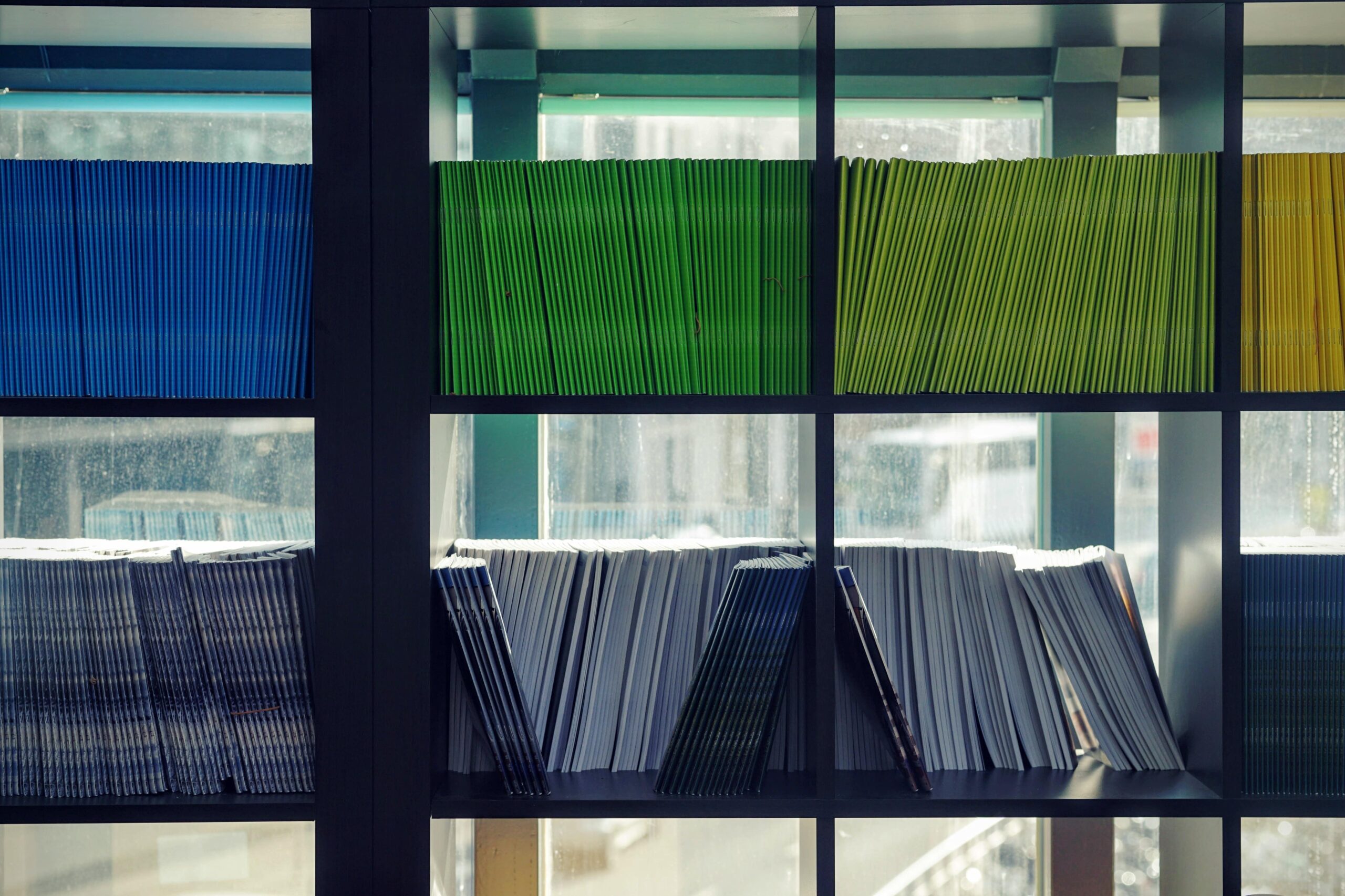 Colourful books lined up in square bookshelves