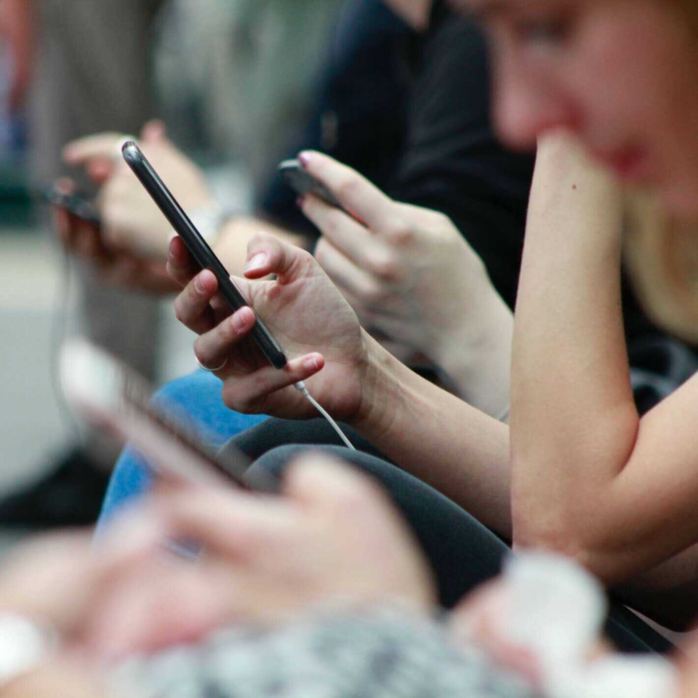 People looking at mobile phones