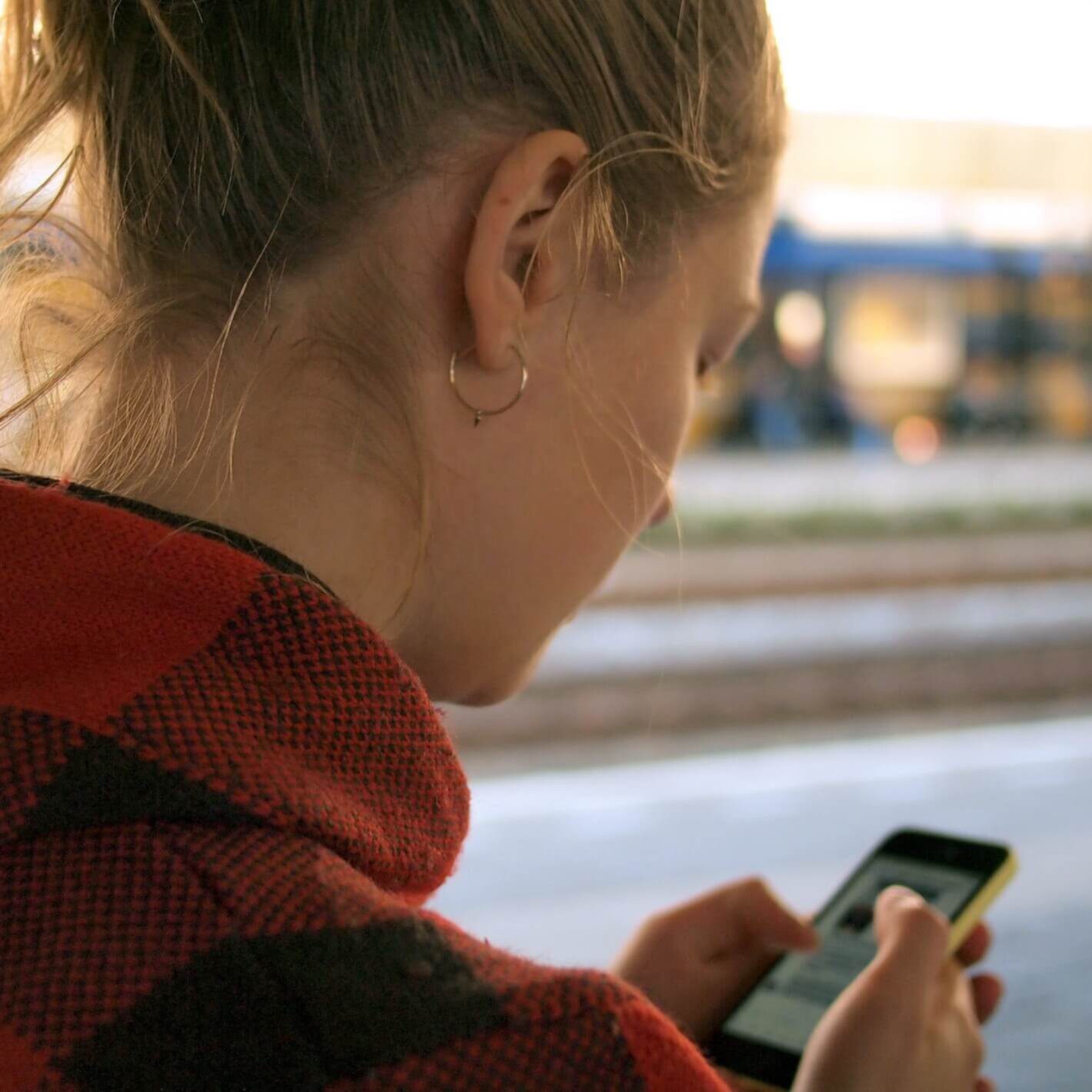 Woman looking at her iPhone