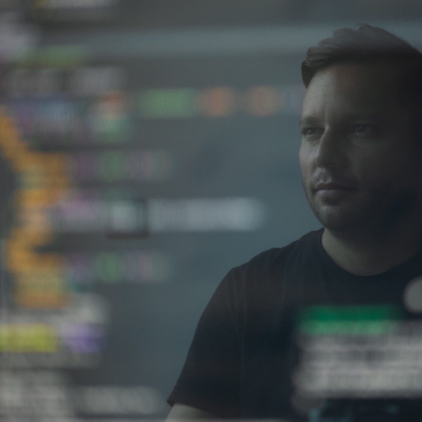 Man looking at a computer screen with code