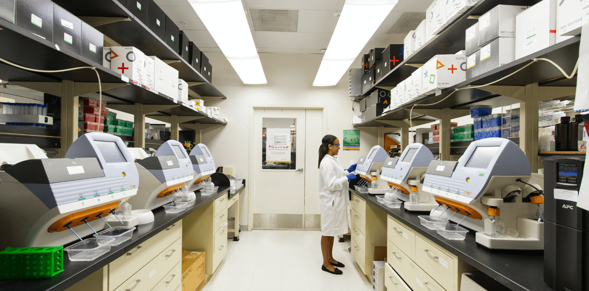 female healthcare professional in lab with computer screens