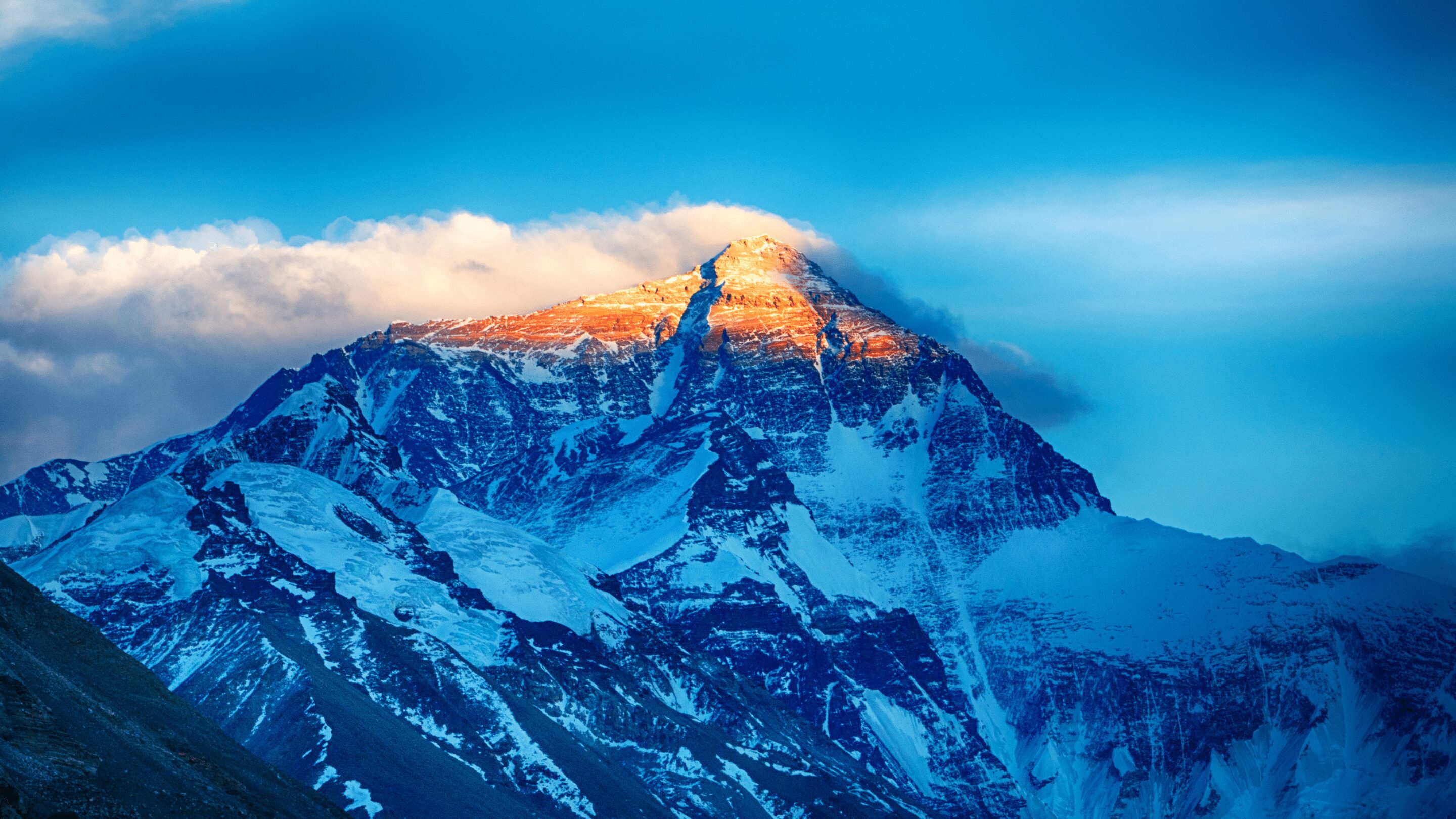 Mount everest with blue sky and clouds in background
