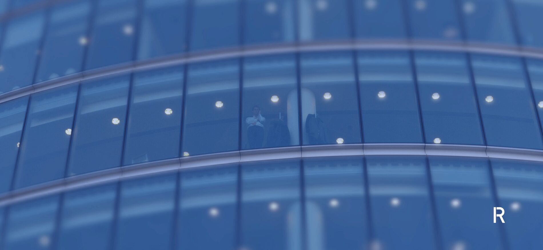 Business man looking out the window of a building