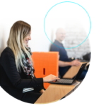 Person sat at laptop smiling at screen