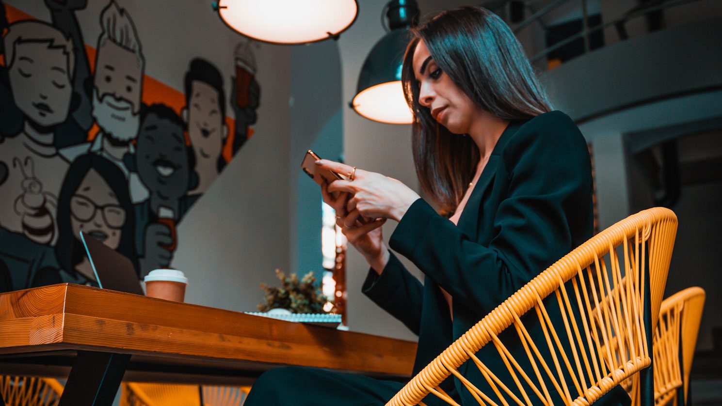 Woman looking at mobile phone in cafe
