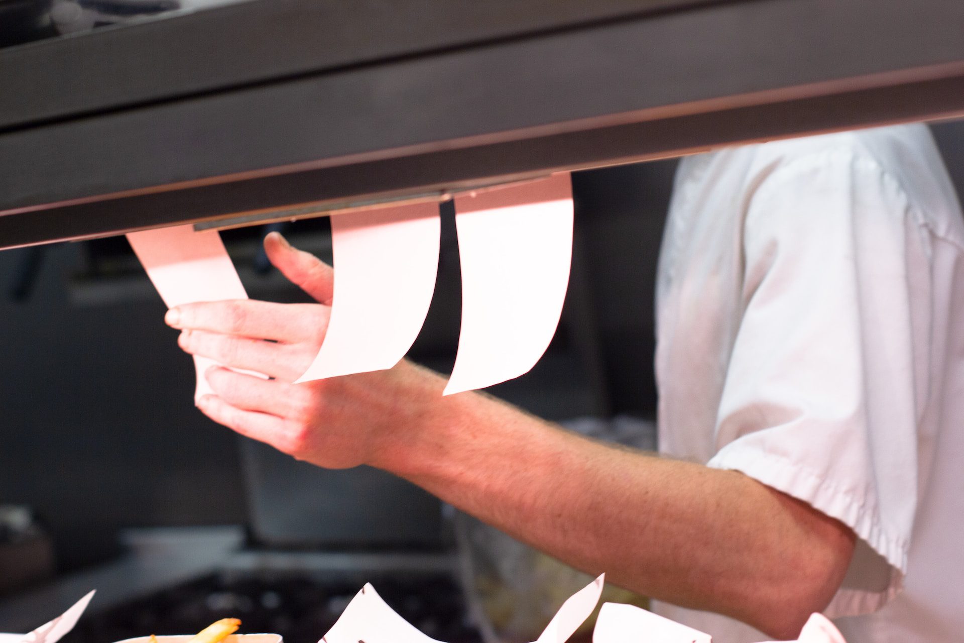 Chef checking restaurant orders in kitchen