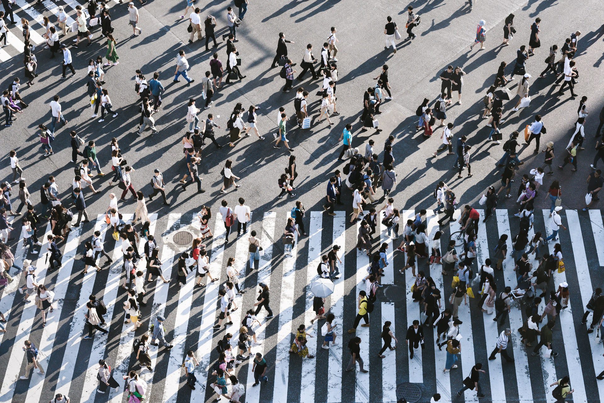 A crowd of people crossing a road