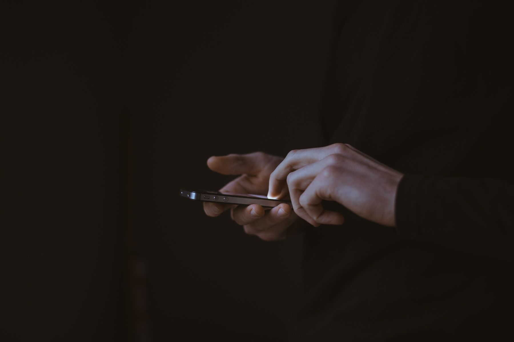 Silhouette photo of person holding a smartphone for CAI