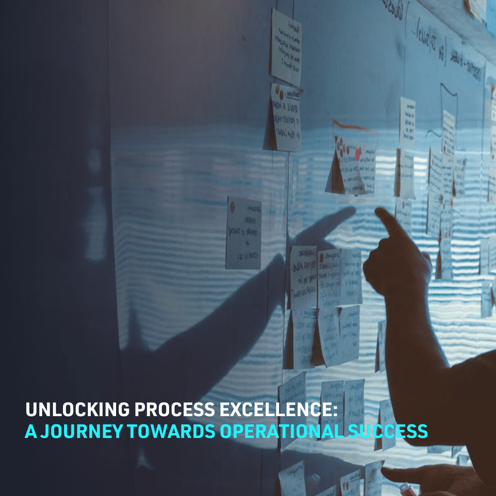 Dark image of a person pointing at a whiteboard with post it notes stuck on the board